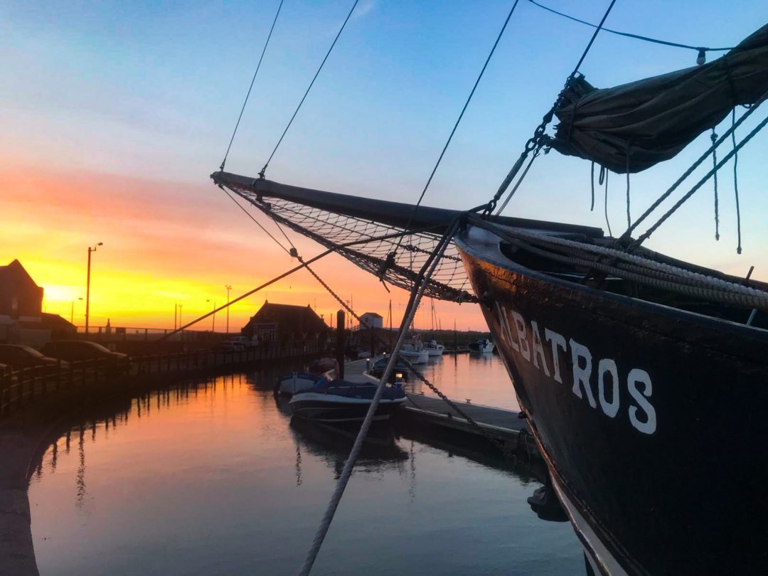 The Albatros restaurant boat with a sunset background. 