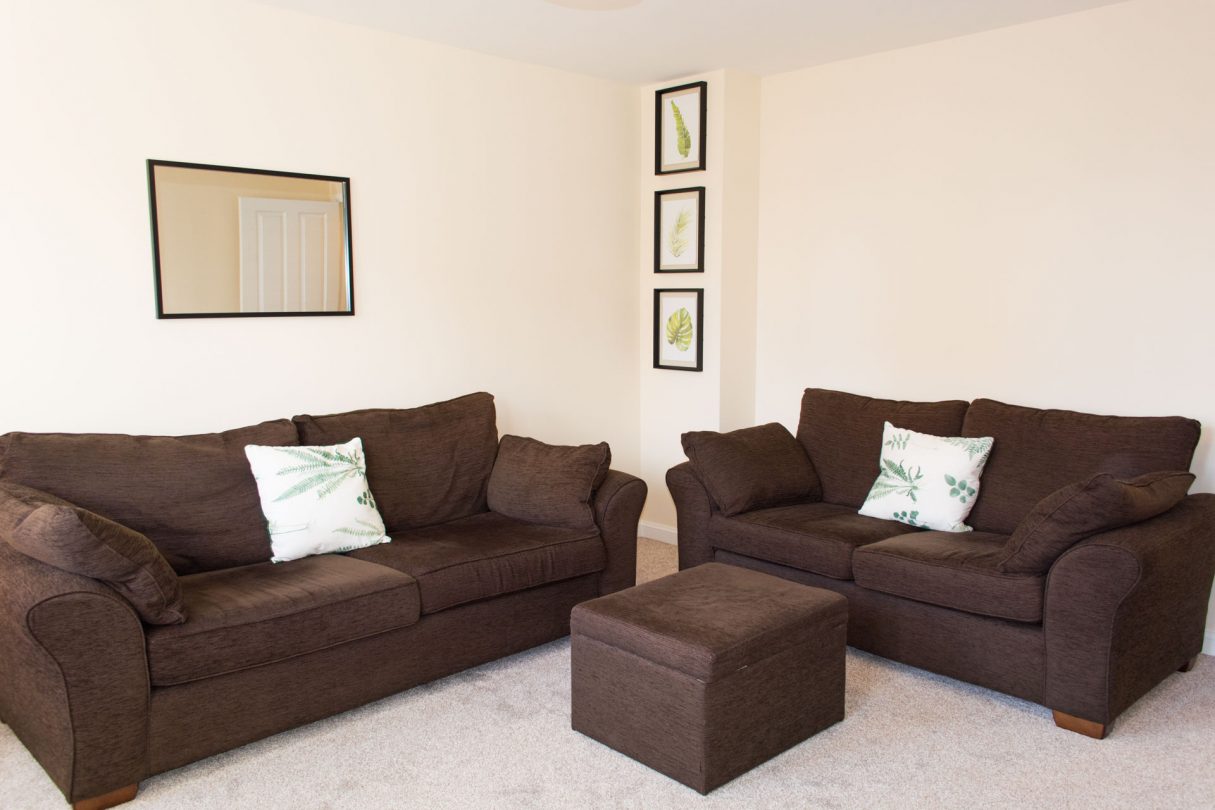 Spacious family living room with large comfortable sofas.