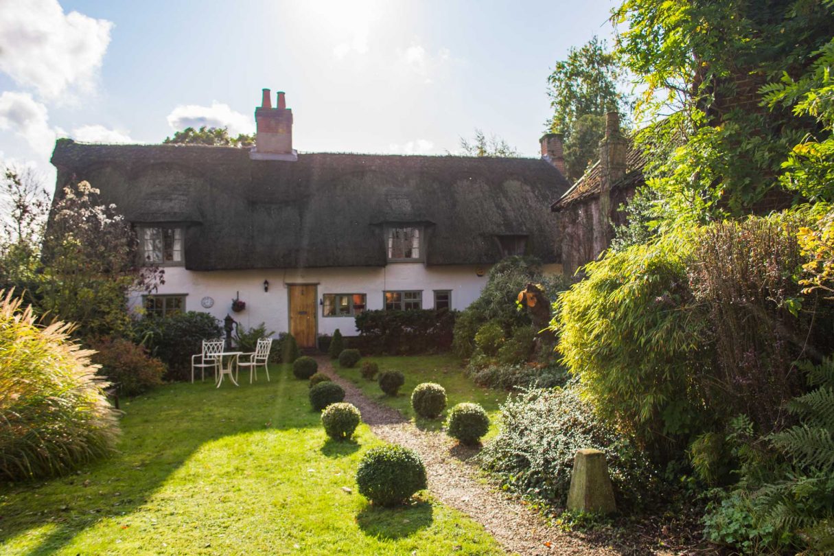 Thatched Cottage in South Norfolk with attractive garden and wooden door. 