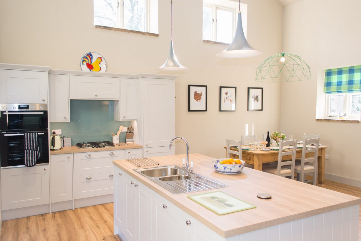 A second photo of the kitchen island, showing the dining table in the background.