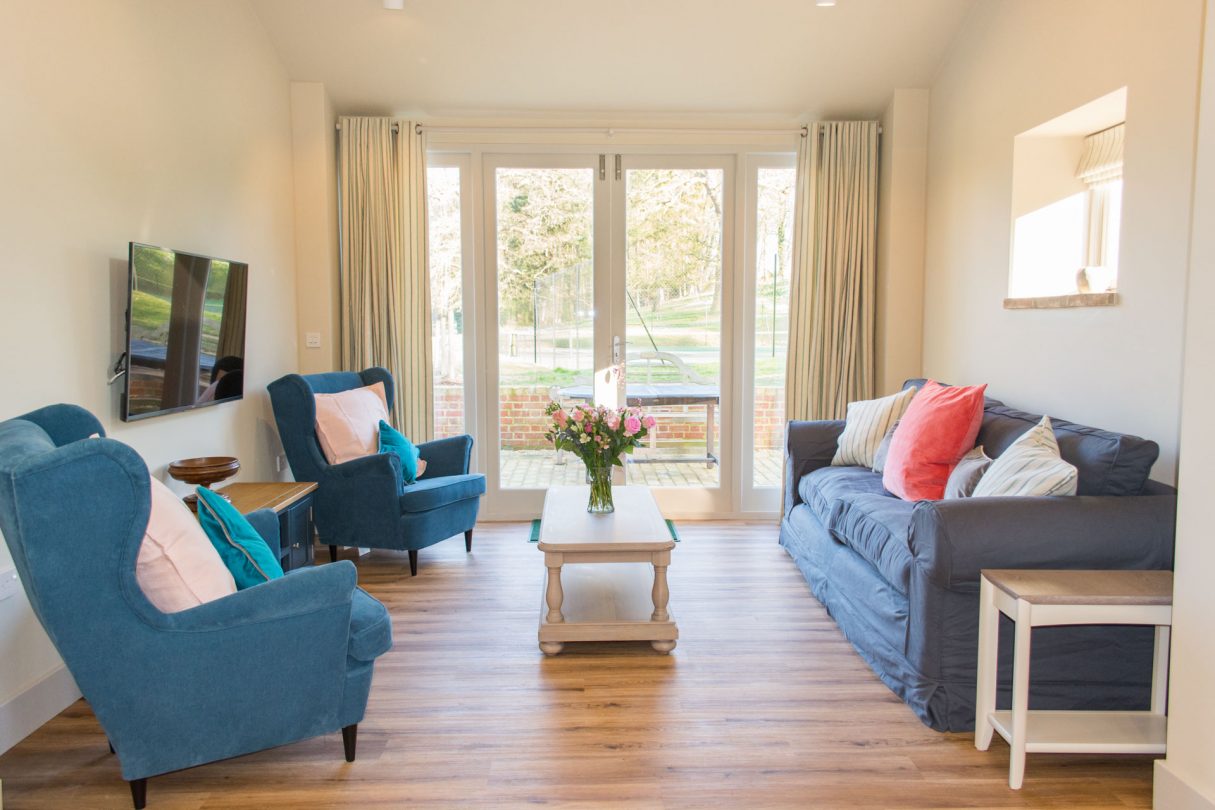 Living area, showing comfy chairs and a large sofa.