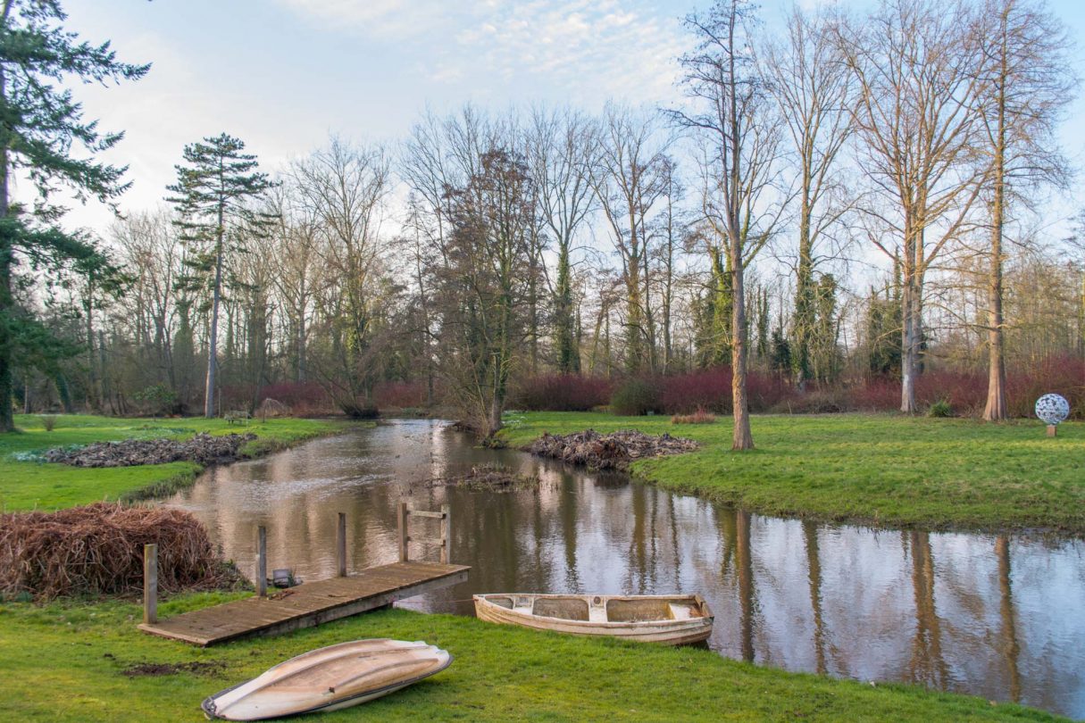 rural grounds and river located outside boathouse barn