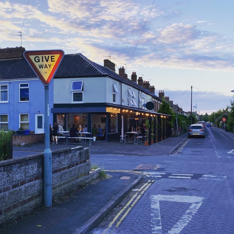 Woolf and Social restaurant from the street corner showing their covered new outside area.