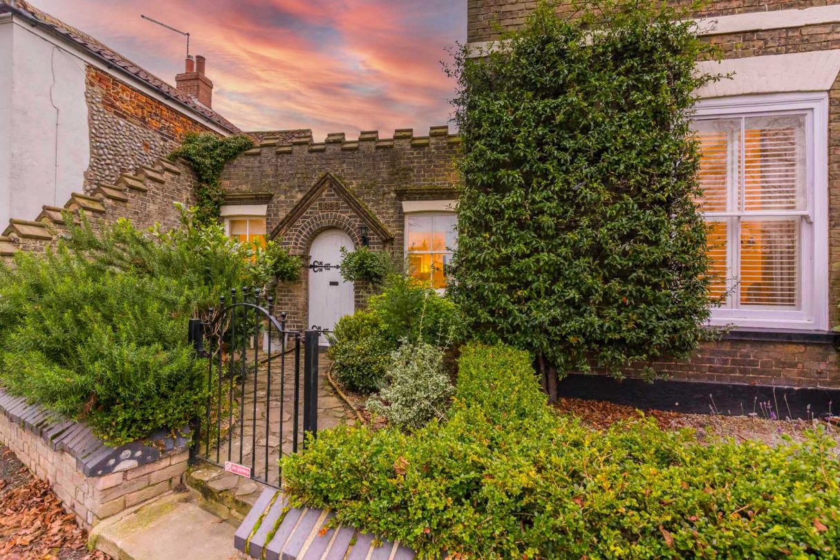 Outside view of Abbey House Cottage with a beautiful sunset.