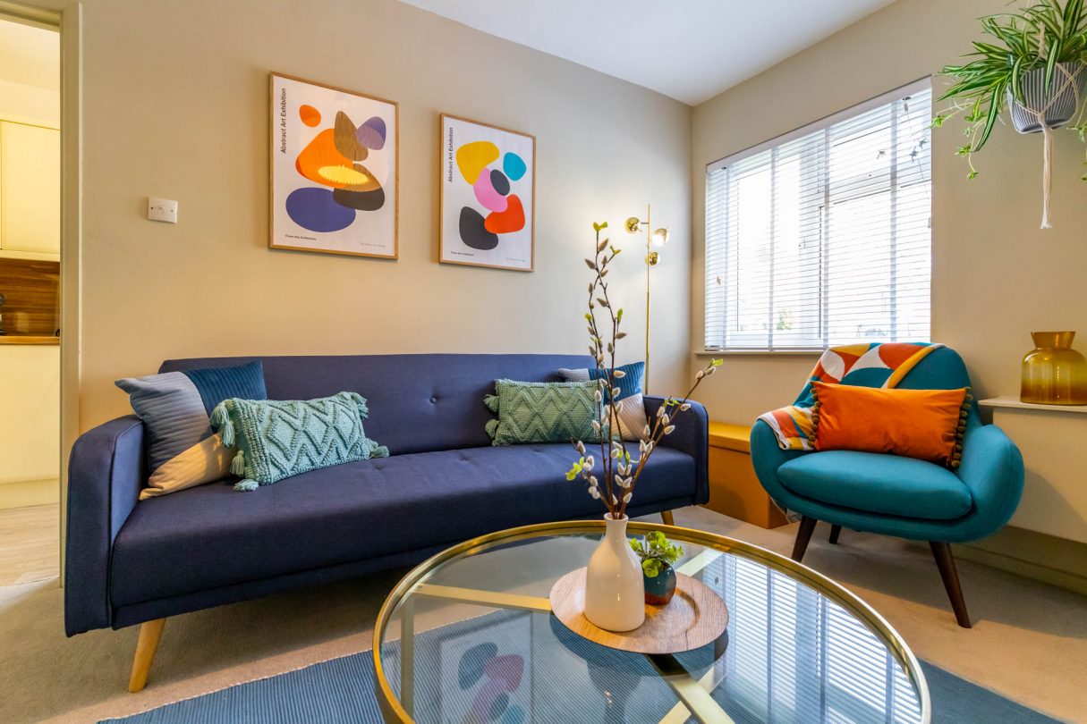 Norwich holiday let, Corner Cottage living room with colourful furnishings including sofa, armchair and coffee table. 