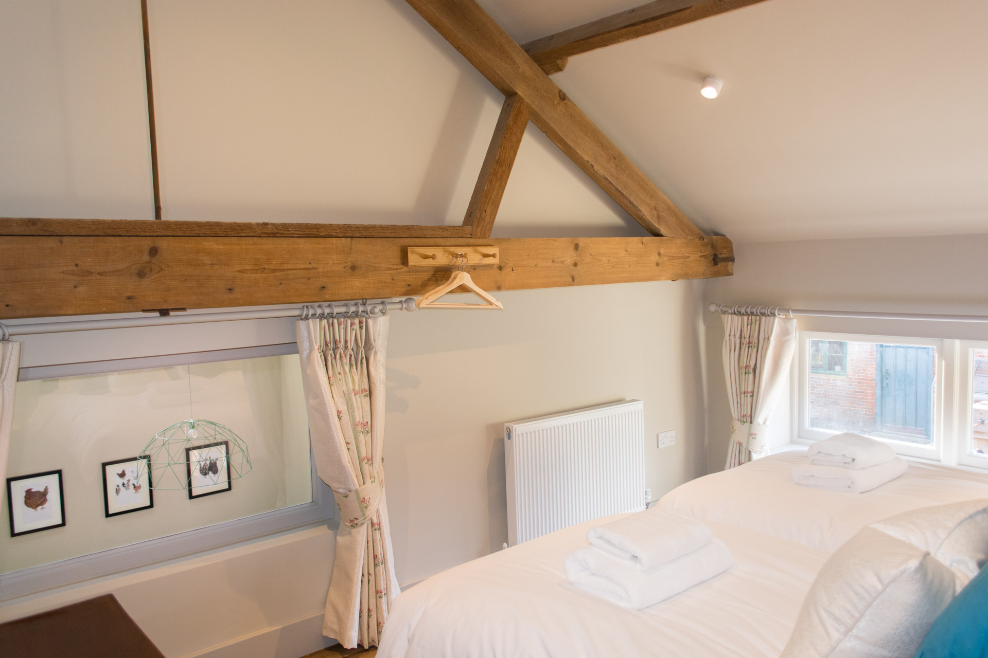 Window and wooden beams in the upstairs twin room of Boathouse Barn.