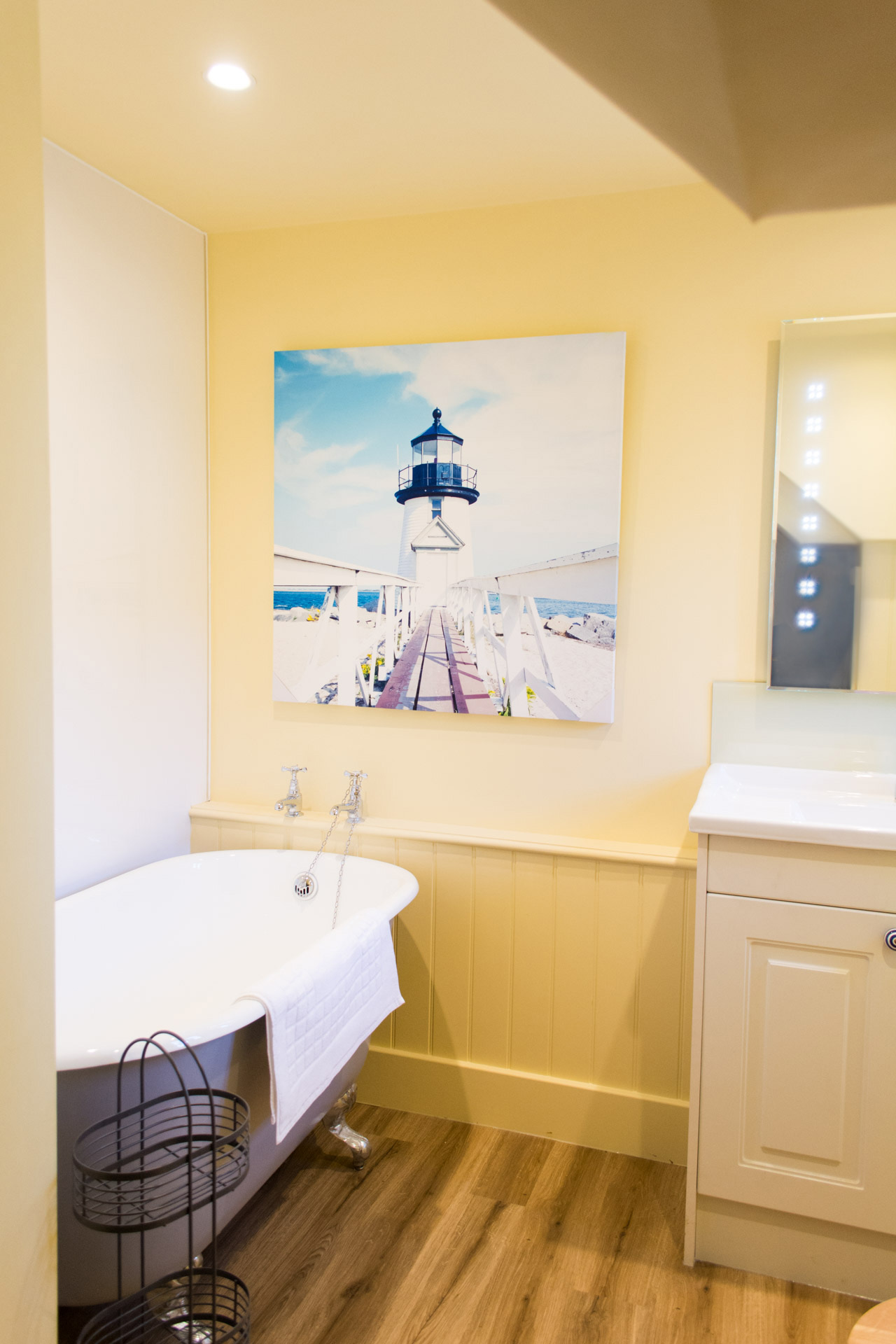 Bathroom photo showing yellow walls and bath tub.