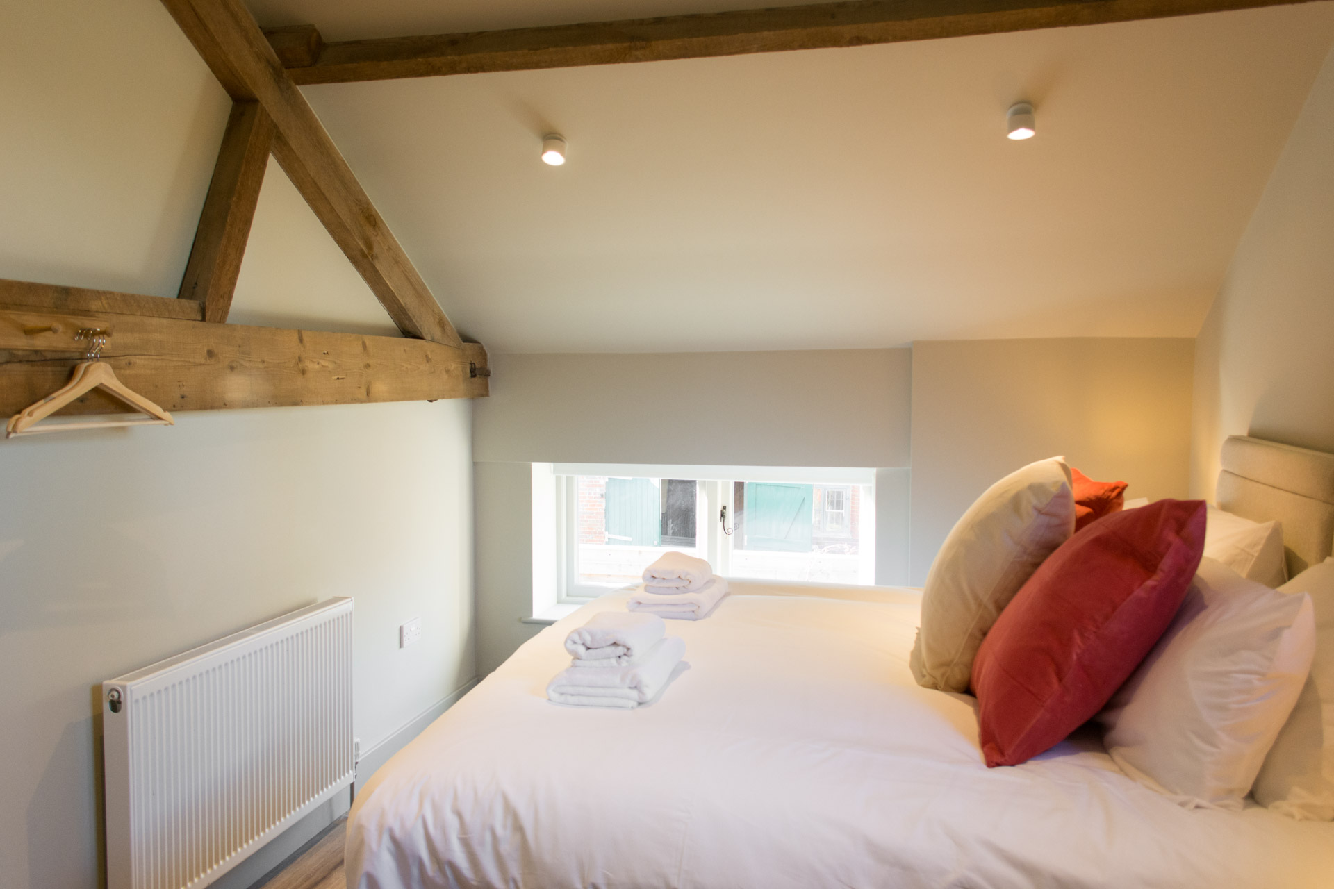 Super-king bedroom showing interior lights and window.