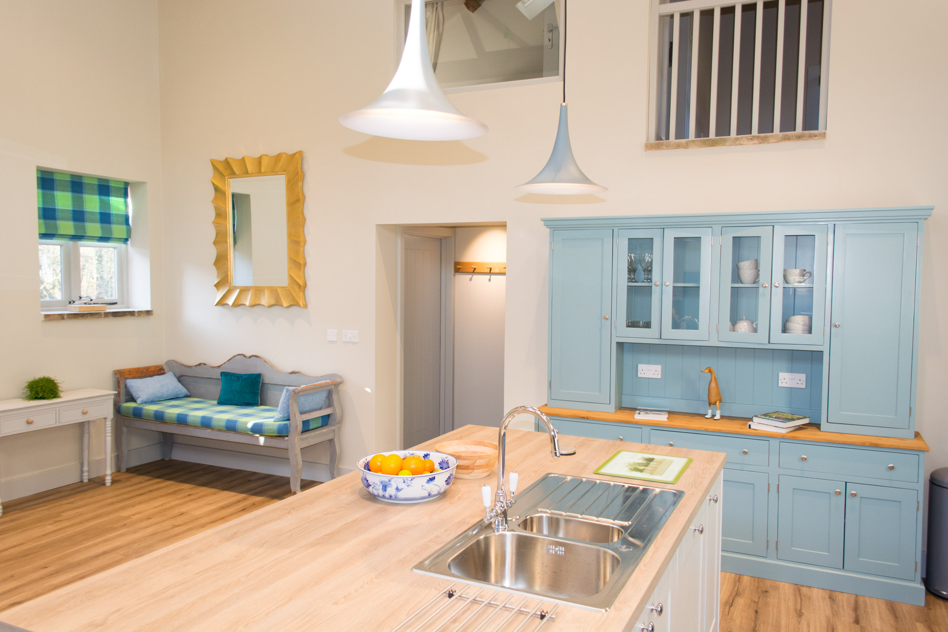 Holiday accommodation interior kitchen shot showing kitchen island and sink.