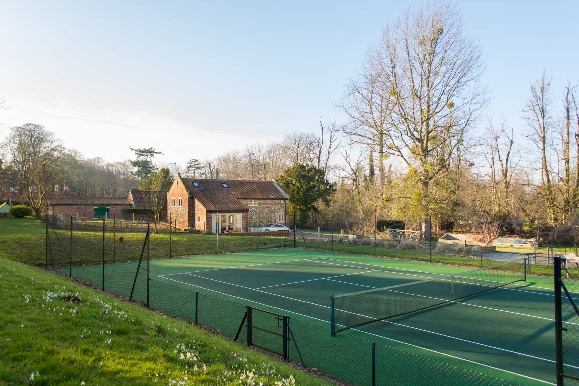 Tennis courts with Boathouse Barn in the background.