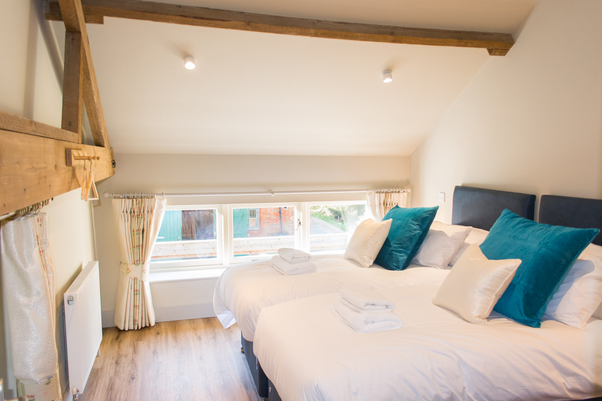 Twin bedroom with blue and white pillows.