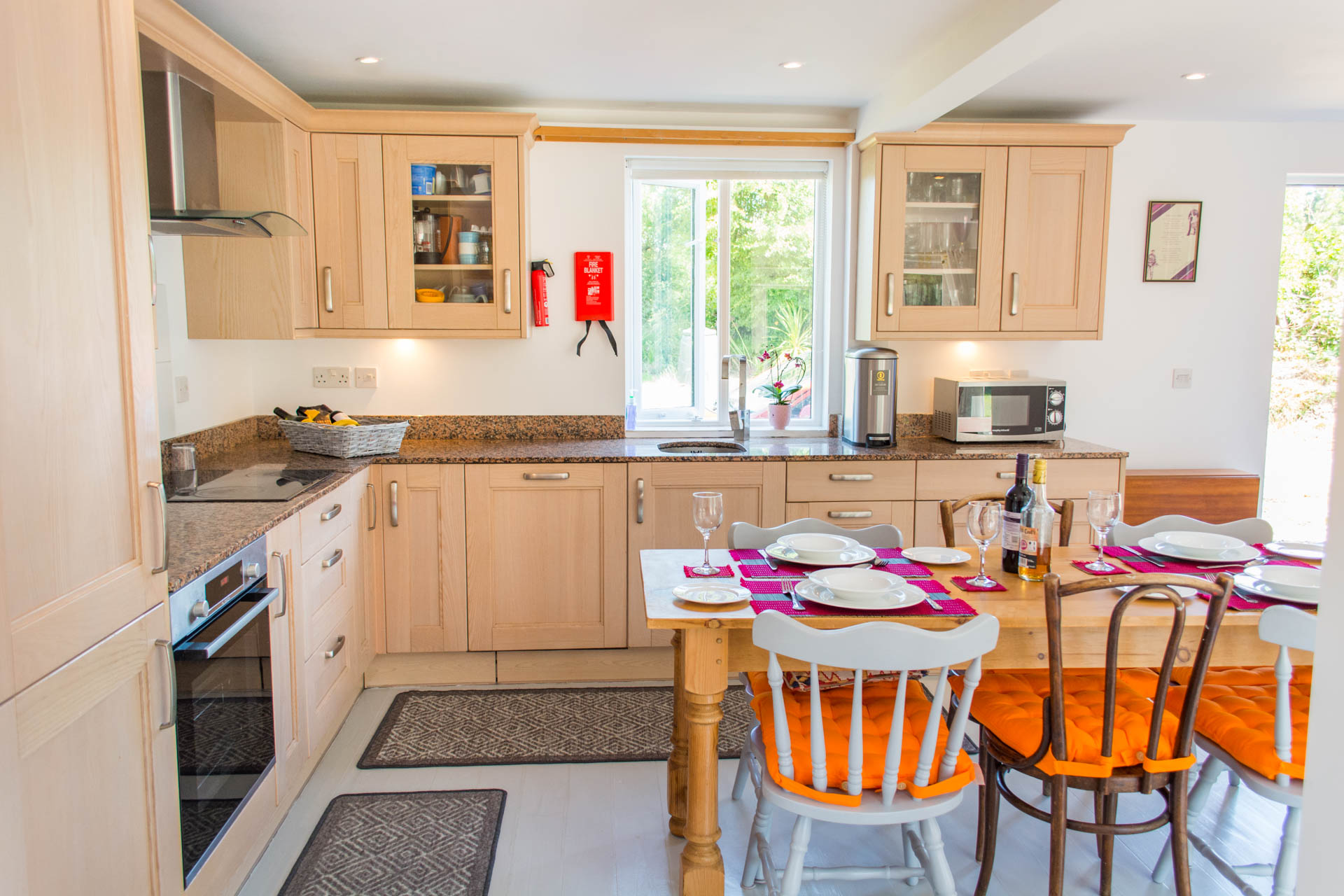 Photo of a modern kitchen, showing part of the dining table and chairs.