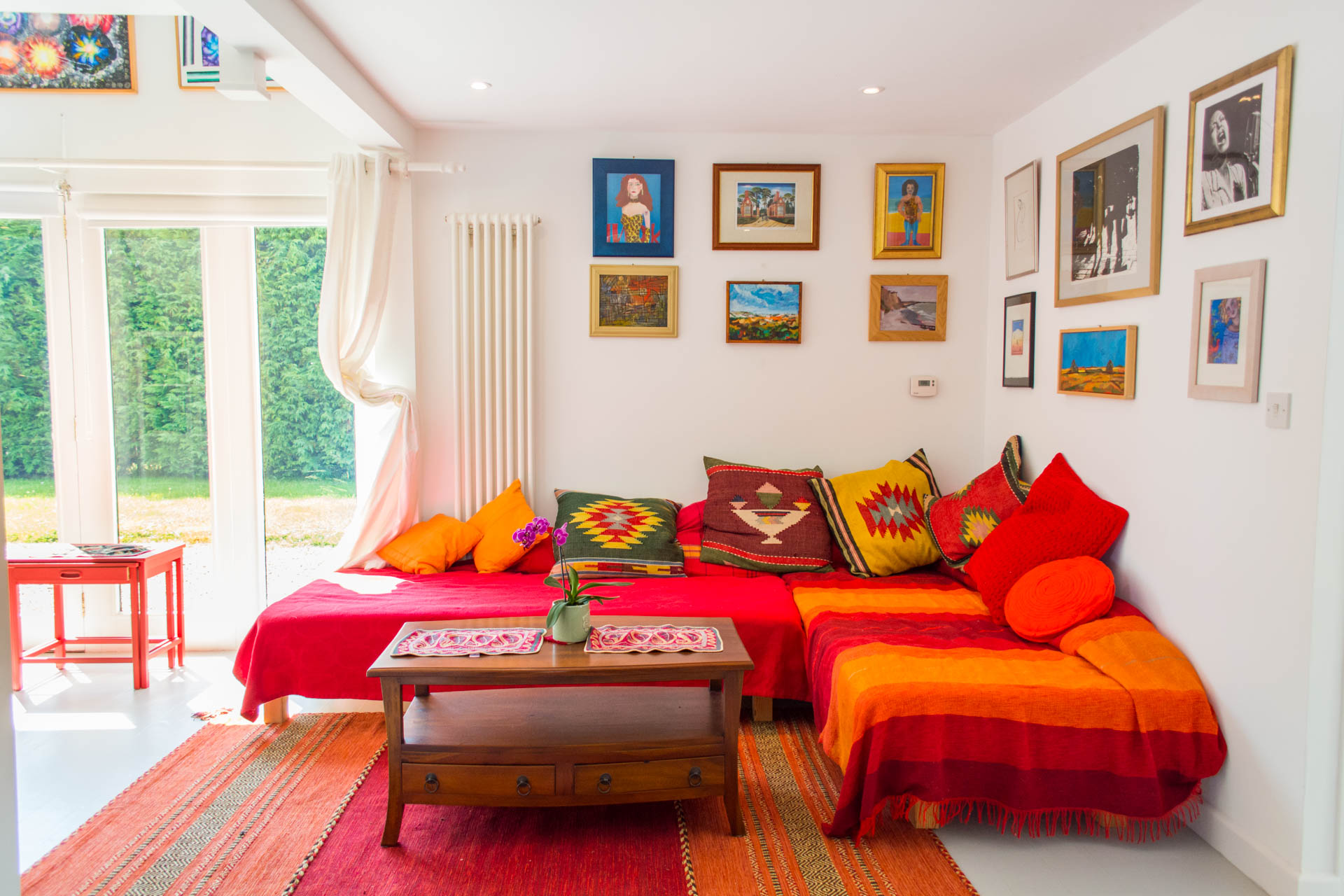 Holiday home living area showing red and orange themed living area.