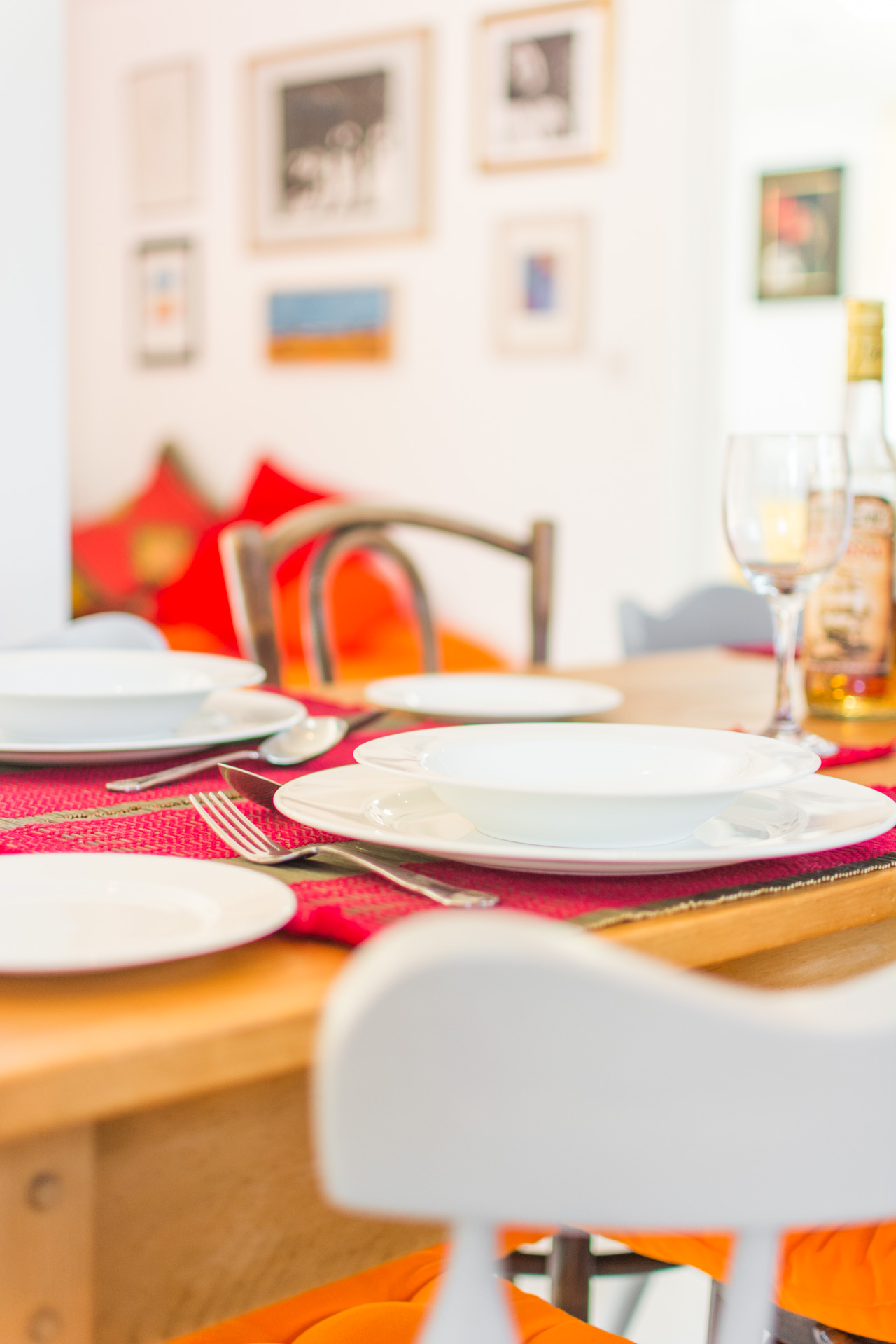 Close up photo of dining table showing plates and cutlery.