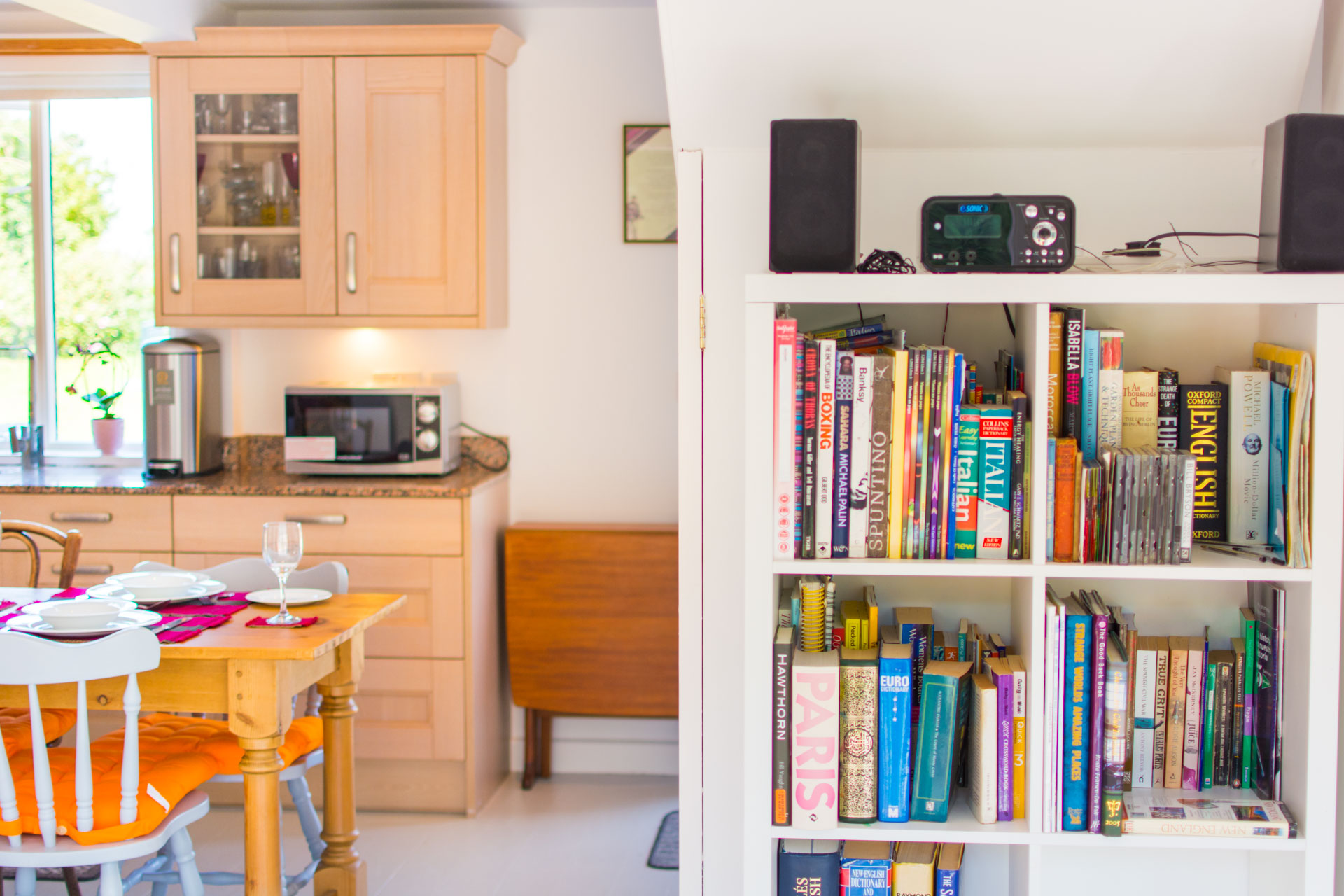 Photo of a book case filled with an array of books.