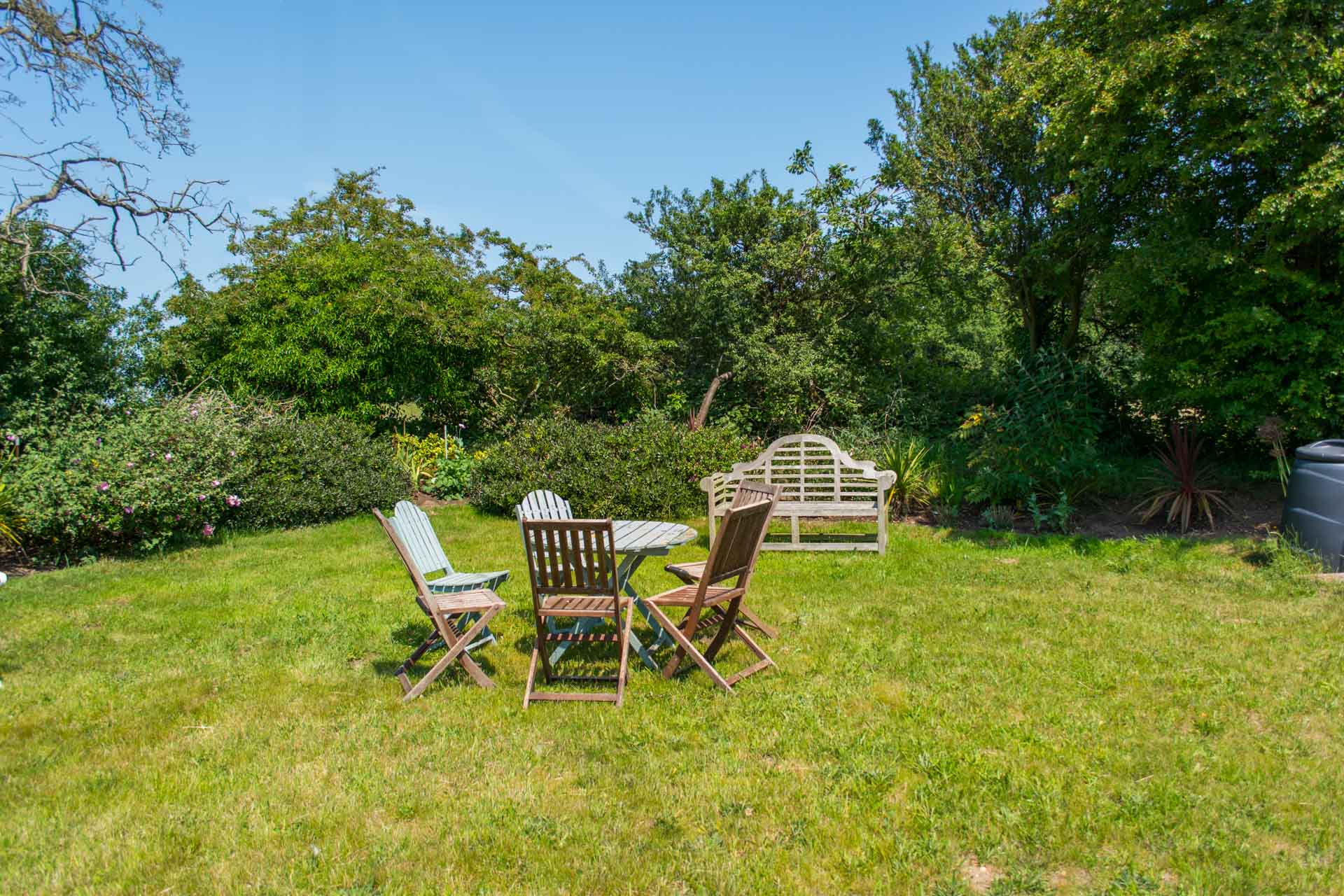 Garden photo showing outside wooden family dinning area.