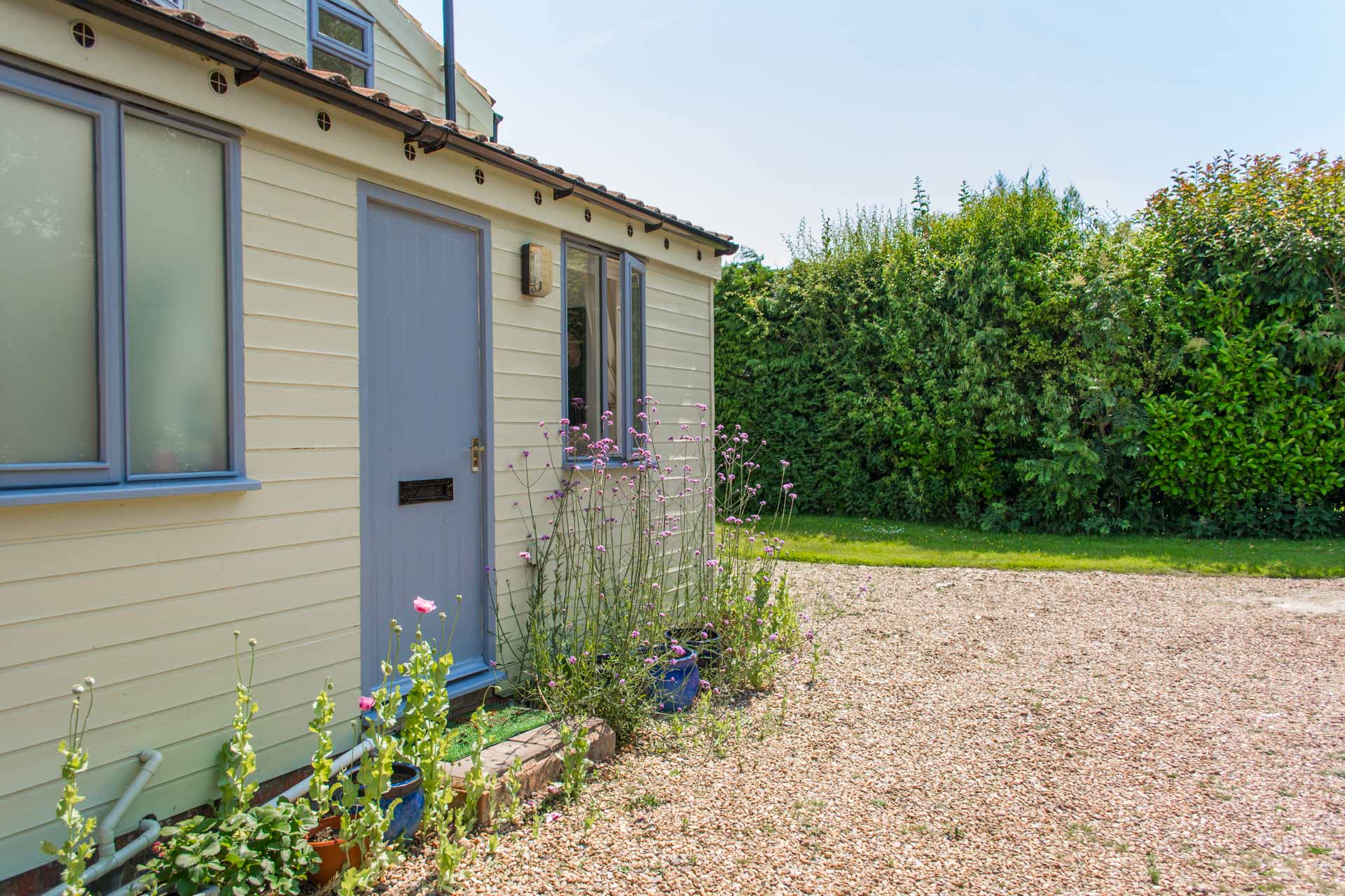 Hen Barn holiday home entrance doorway with gravel footpath.